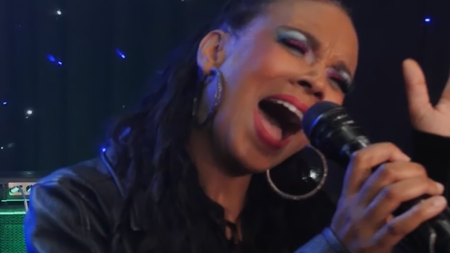 Backing vocalist Jamila singing with eyes closed